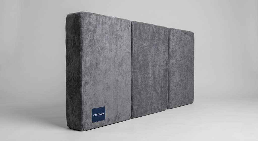 Castaway Bed 31-inch center platform mattress shown in three segmented sections with grey velvet cover and Castaway branded label, designed to fit the floor-anchored center platform when the motorized split king bed is in the open position