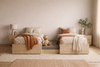 Castaway Bed motorized split king bed in open position without headboard, lifestyle bedroom setting showing floor-anchored center platform revealed with a teddy bear seated on it, demonstrating safe sleeping space for children or pets, with warm neutral decor and natural light